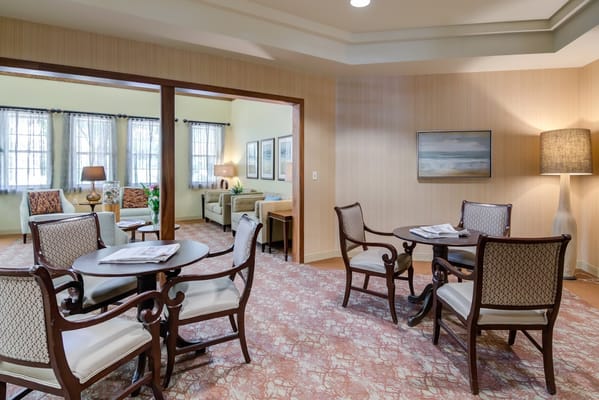 A bright and inviting living area with seating and tables.