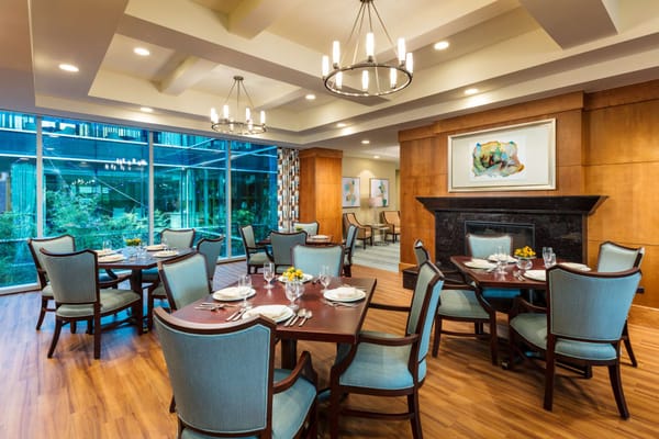 Dining area featuring tables set for a meal with large windows