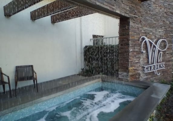 Outdoor water feature with a soothing waterfall and seating area