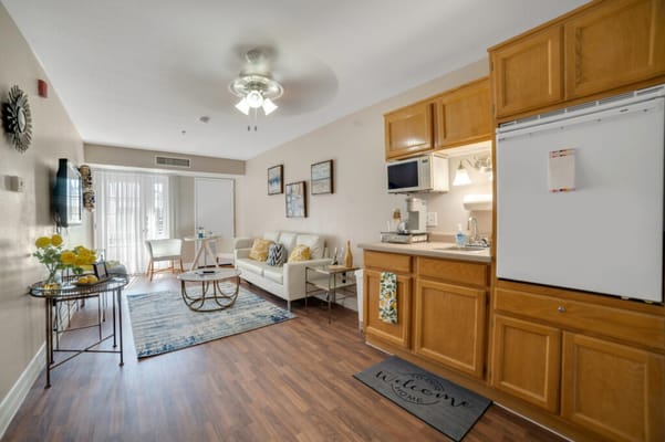 A cozy resident room with sitting area and kitchen
