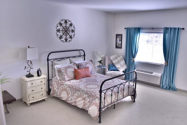 Bright and inviting resident room with a bed and decor