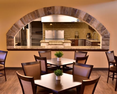 Dining area with tables and view into kitchen