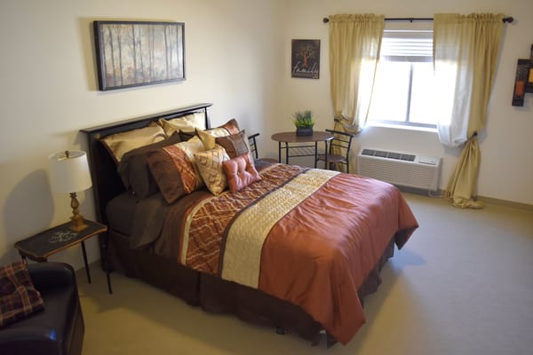 Cozy interior of a resident's private room with a bed