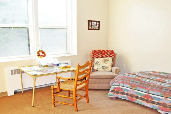 Cozy resident room with chair and bed