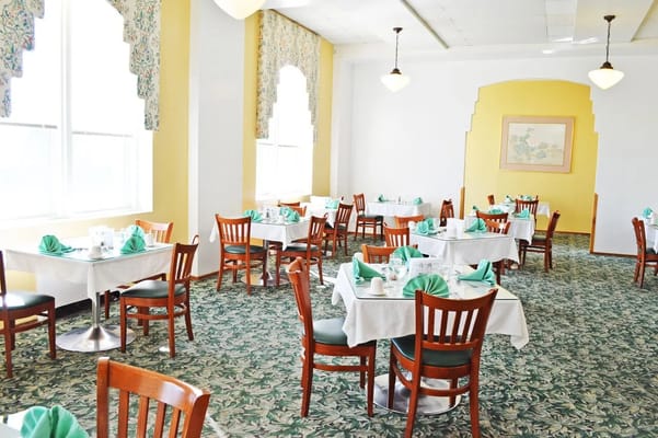 Bright dining room with tables set for meals