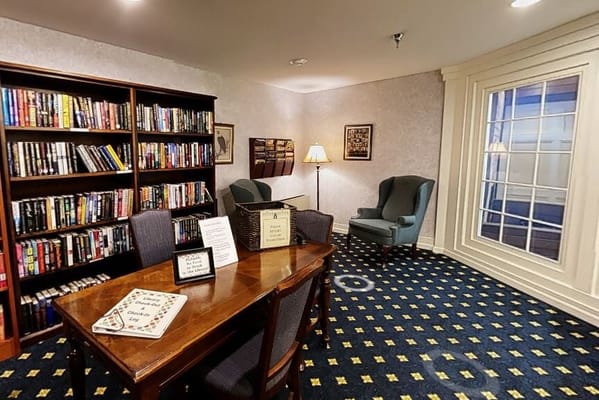 Cozy reading area with bookshelves and a table in the library.