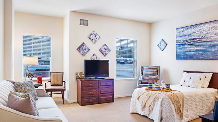 A bright and cozy resident room with furniture and decor