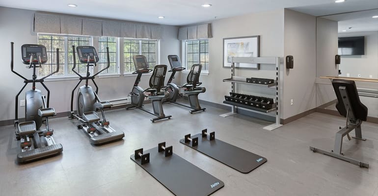 Well-equipped gym featuring exercise machines and weights
