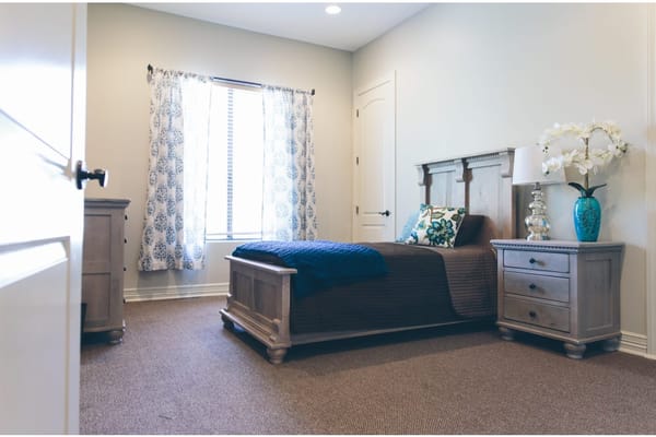 Cozy private room with a bed and bedside table