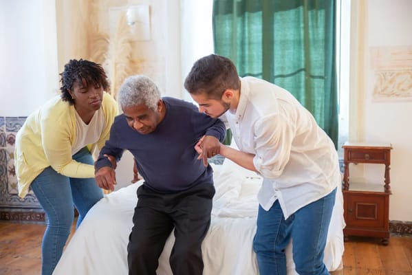 Care staff assisting a resident in a room