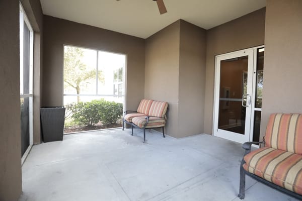 Seating area on a porch with plants