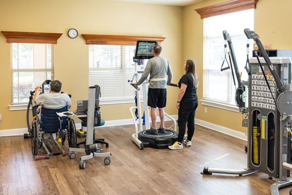 Residents and staff engaging in physical therapy activities