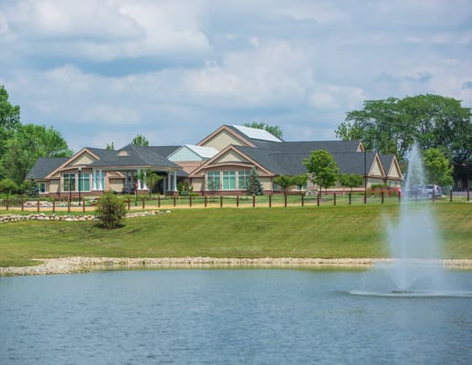 Exterior view of Hoosier Village by a pond