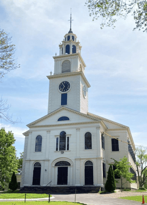 Historic building with a clock tower and outdoor landscaping