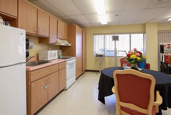 Bright kitchen area with seating and flowers
