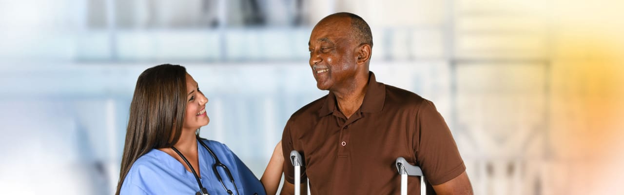 Staff assisting a resident in an interior setting