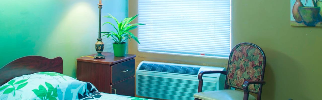 Cozy resident room with a bed and chair