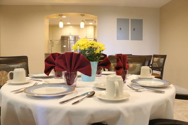 Dining table set with flowers and napkins in an inviting room