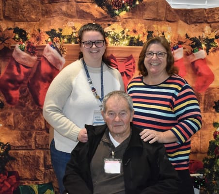 Residents and staff posing together in a festive setting
