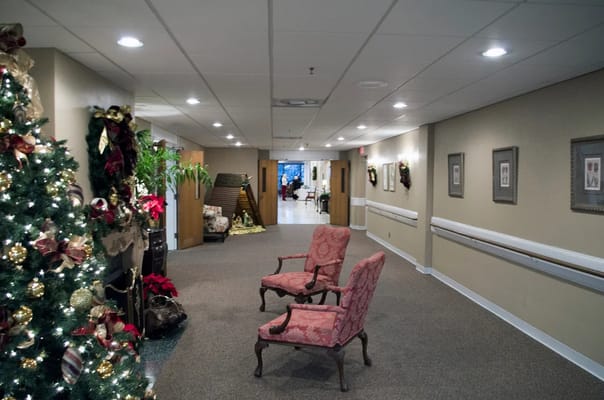 Festively decorated corridor with seating and holiday decorations