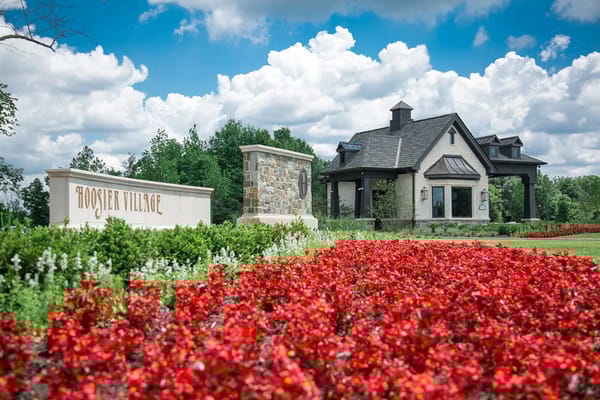 Exterior view of Hoosier Village with flowers and building