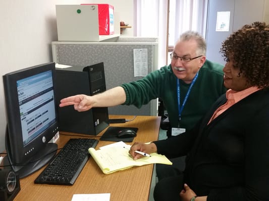 Staff assisting residents with computer usage