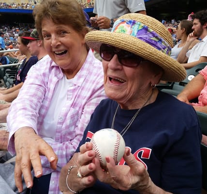 Two residents enjoying a baseball game