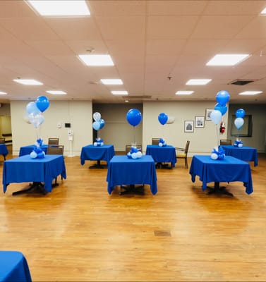 Dining room set up for a celebration with blue decor