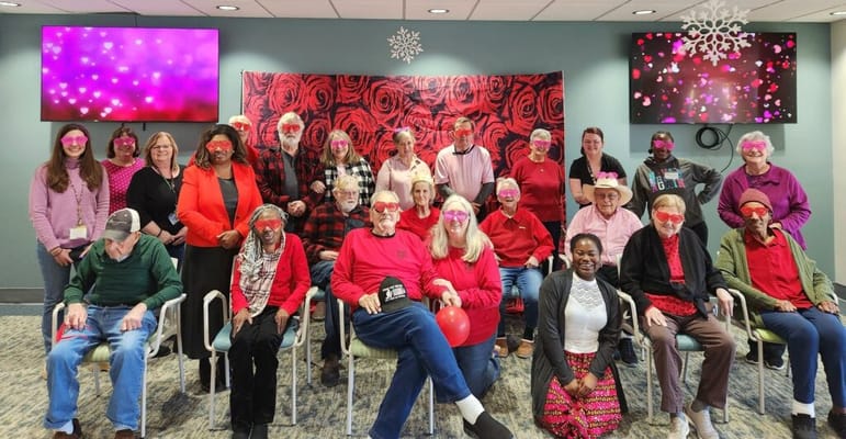 Residents and staff celebrating in a decorated common area