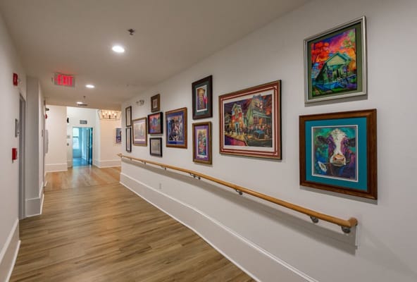Colorful art displayed along a corridor in the facility