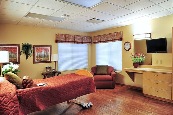 Comfortable resident room with bed and seating area