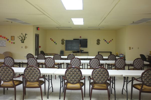 Interior view of a common activity room with tables and chairs
