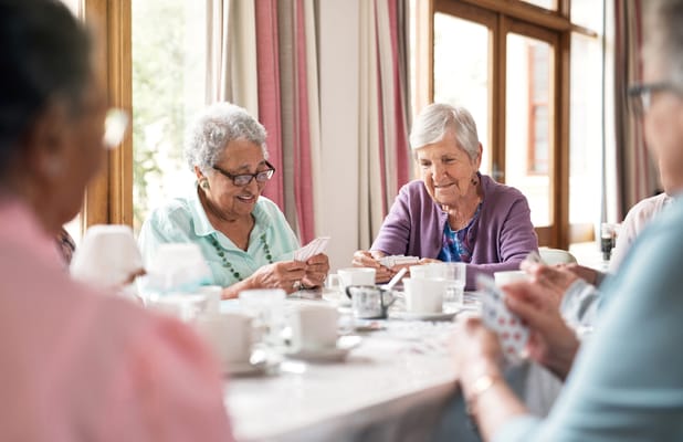 Residents enjoying a card game in a common area