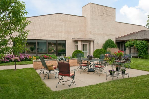 Outdoor seating area with tables and flowers