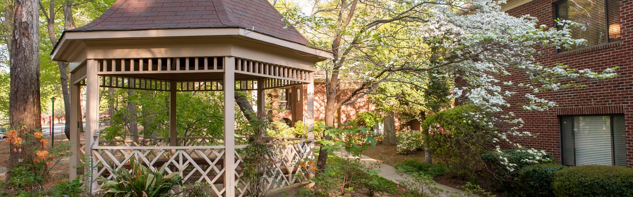 Gazebo surrounded by lush greenery in a senior living community