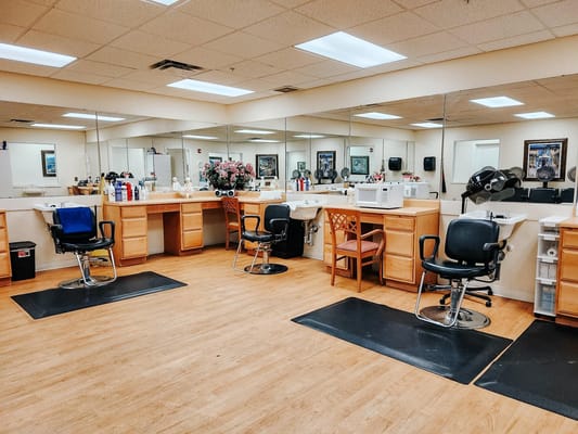 Hair salon area with styling chairs and mirrors