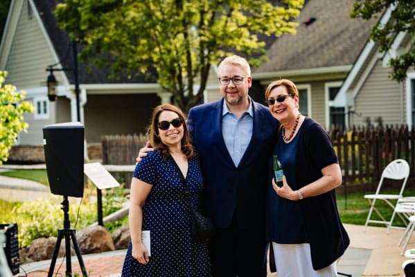 Three people posing in an outdoor space