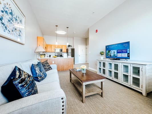 Bright living area with modern furnishings and a TV