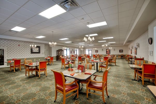 Dining area with tables and chairs arranged for residents.