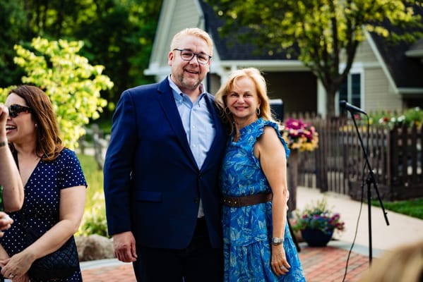 Two people posing together outdoors at an event