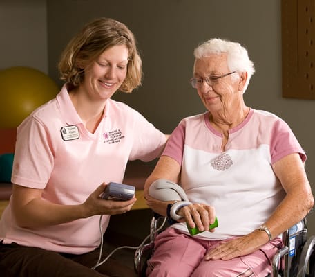 Staff member assisting a resident with medical monitoring