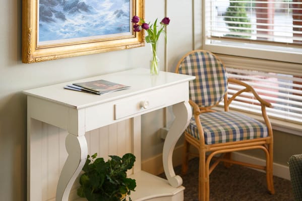 Bright interior corner with chair and flowers