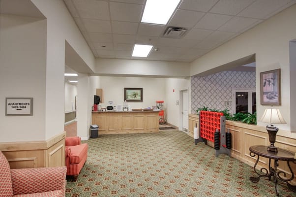 Bright common area with seating and reception desk