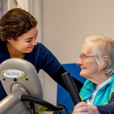 Staff assisting a resident during activity