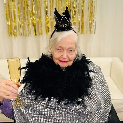Resident celebrating New Year's Eve with a drink