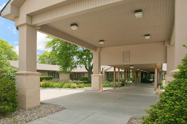 Entrance of a senior living facility with a covered walkway