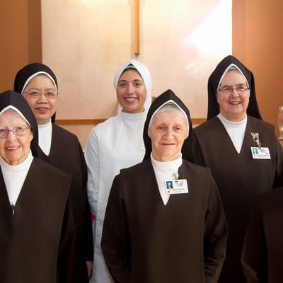 Group of staff members in uniforms smiling together