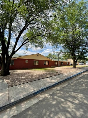 Exterior view of a skilled nursing facility with trees