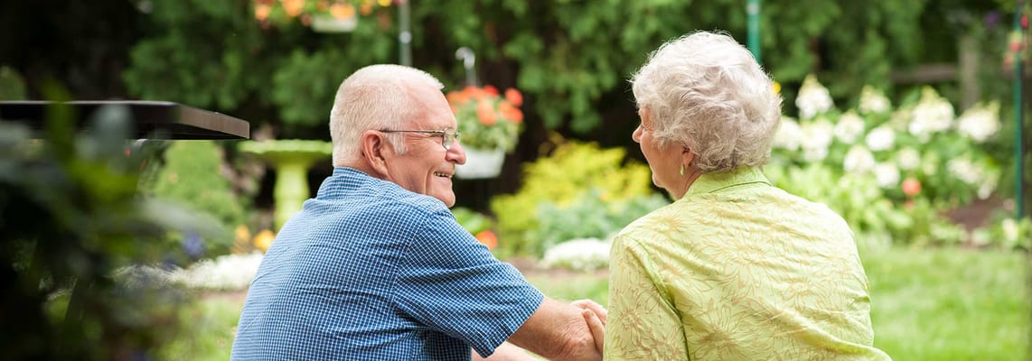 Two residents enjoying time together in a garden