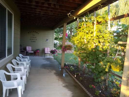 Covered porch with seating and garden plants